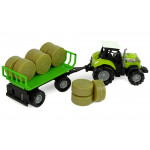 Zelený traktor s prívesom so senom