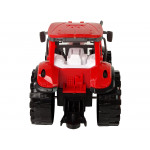 Červený traktor s oranžovým kultivátorom