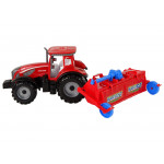 Červený traktor s pluhom na trecím pohonom